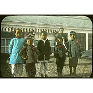 A group of Chinese children in front of a building<br/>