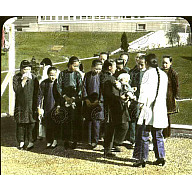 Group of Chinese women in traditional dress, one woman is holding a baby<br/>